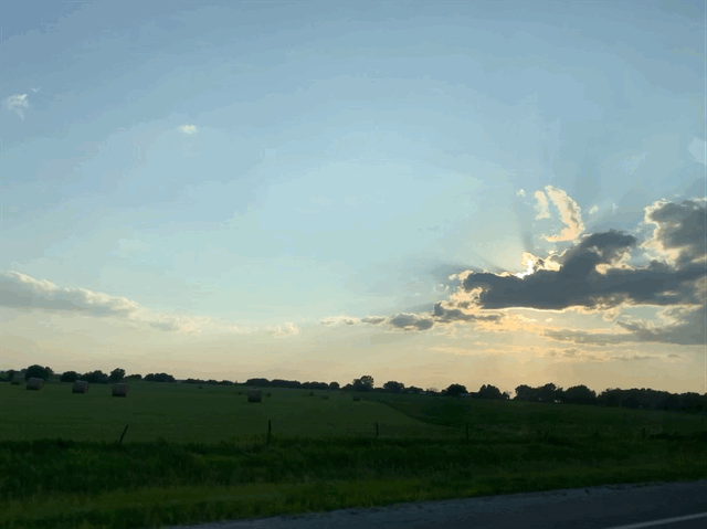 A gif of rolling Iowa hills driving by